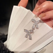 Delicate bow sparkling diamond earrings
